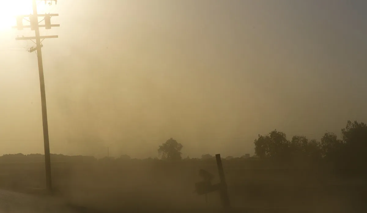 Landscape with dust in the air obscuring the sun during California drought