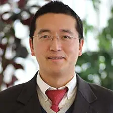 a man wearing glasses and a suit