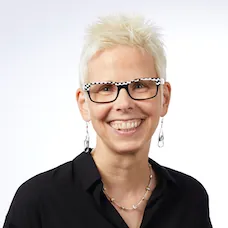 a woman with short hair wearing glasses and a black shirt