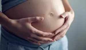 a pregnant woman holding her belly