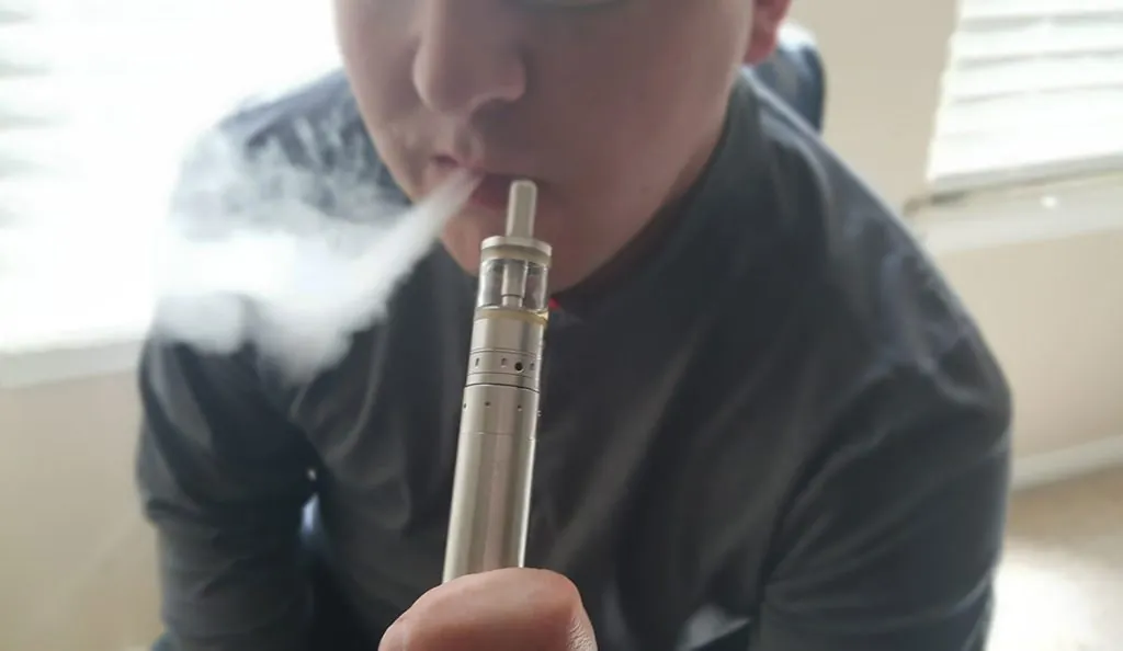 a person smoking a vaporizer