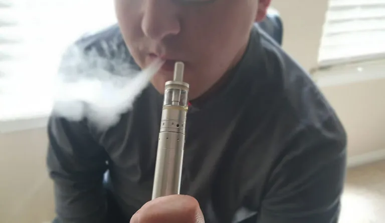 a person smoking a vaporizer