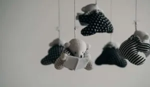 a mobile with teddy bears and a book