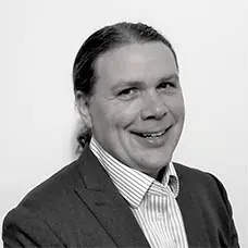 a man in a suit smiling
