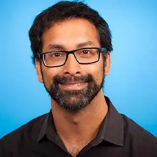 a man wearing glasses and a black shirt