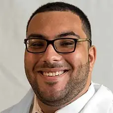 a man wearing glasses smiling