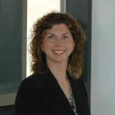 a woman smiling with curly hair