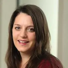 a woman with long brown hair smiling