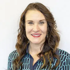 a woman with long brown hair smiling