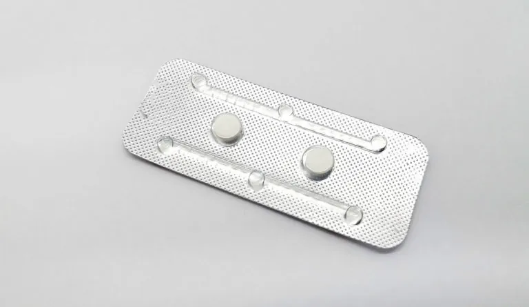 a white pills in a silver package