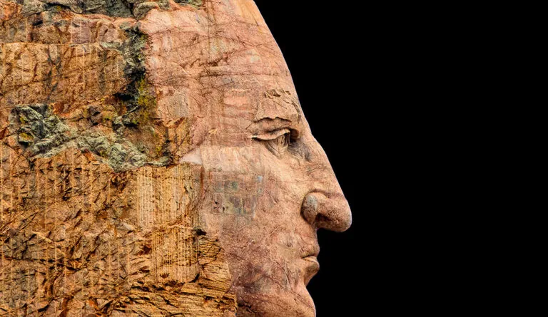 a close up of a face carved into a rock