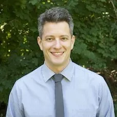 a man in a blue shirt and tie