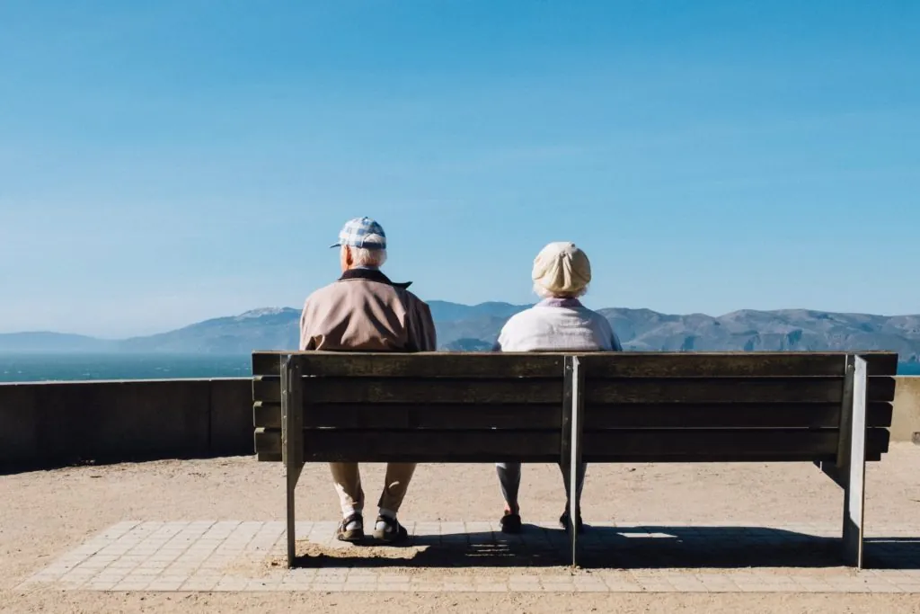 a man and woman sitting on a bench