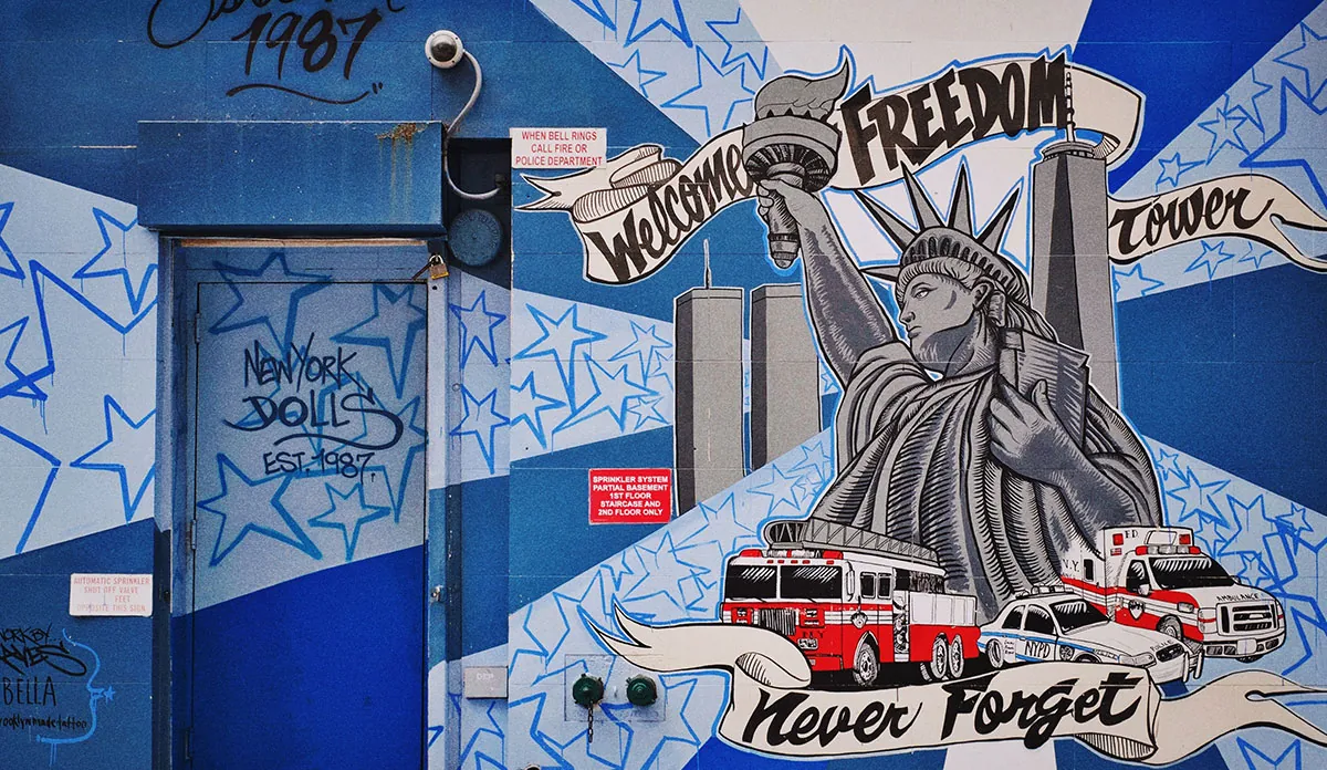 a blue and white wall with graffiti