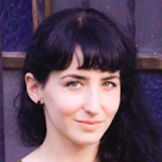 a woman with black hair and bangs