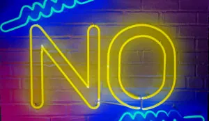 a neon sign on a brick wall