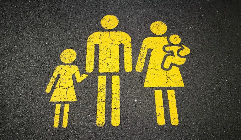 a yellow painted sign on the ground