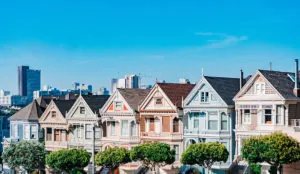 a row of houses with trees in front of them