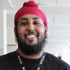a man with a beard wearing a red head scarf