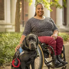 a woman in a wheelchair with a dog