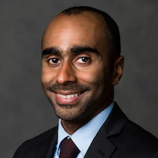 a man in a suit smiling