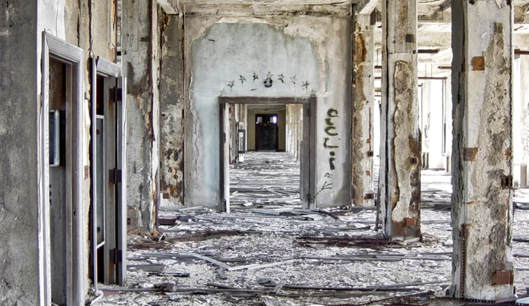 a hallway with a broken wall