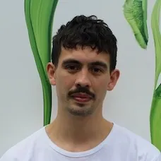 a man with a mustache and a white shirt