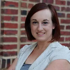a woman with short hair wearing a striped jacket