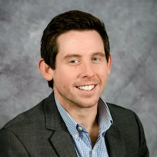 a man in a suit smiling