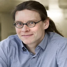 a man wearing glasses and a blue shirt