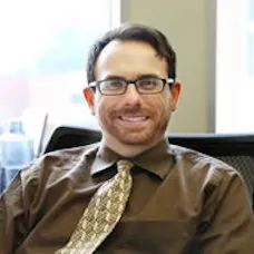 a man wearing glasses and a tie