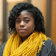 a woman wearing a yellow scarf