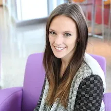 a woman sitting in a purple chair