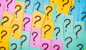a group of colorful papers with question marks