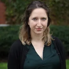 a woman with long hair wearing a black sweater
