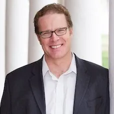 a man in a suit smiling