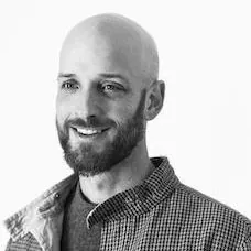 a man with a beard smiling