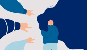 a group of hands pointing at a person's face