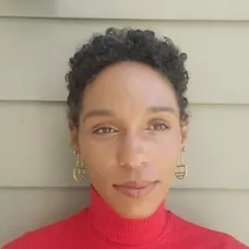 a woman in a red turtleneck