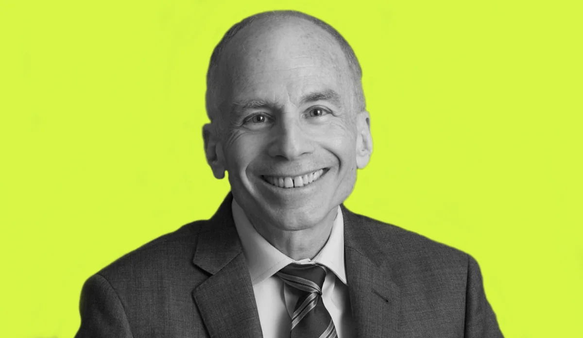 a man in a suit smiling