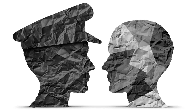 a man's head with a hat facing each other