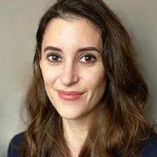 a woman with long brown hair smiling