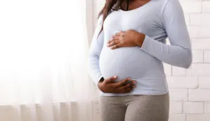 a pregnant woman holding her belly