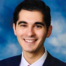 a man in a suit smiling