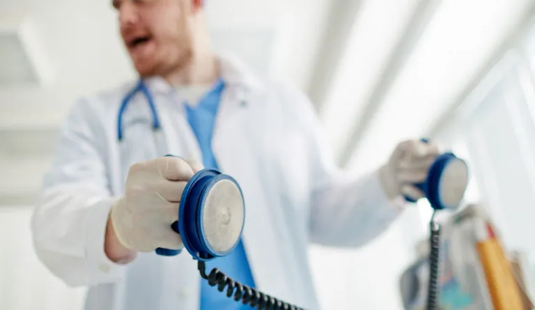 doctor resuscitating unseen person