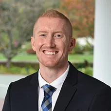 a man in a suit smiling