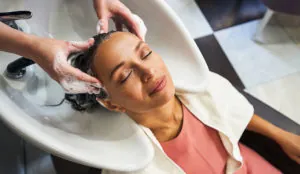 a woman getting her hair washed