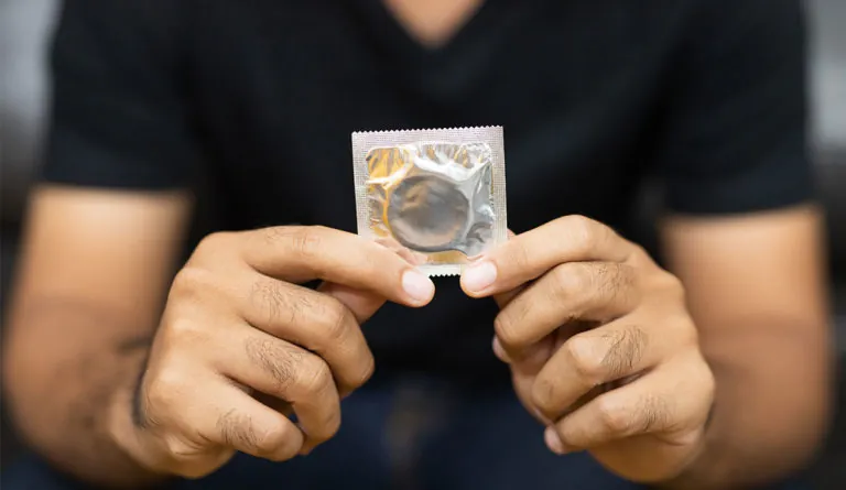 a person holding a condom