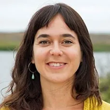 a woman with long brown hair smiling