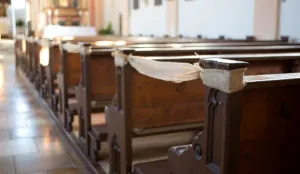 a wooden benches with a burlap ribbon